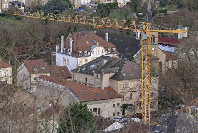 Toits de Knutange vus d'en haut, maisons de la vallée et grue de chantier