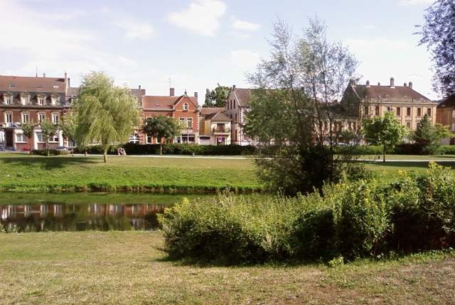 L'Orne à Rombas, rivière bordée d'arbres et de maisons
